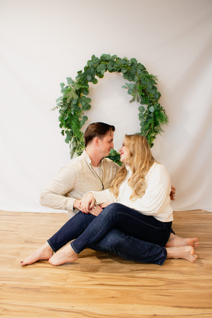 Couples posed during Christmas Mini Session indoors in Roseburg Oregon by McKenzie Strong Photography.