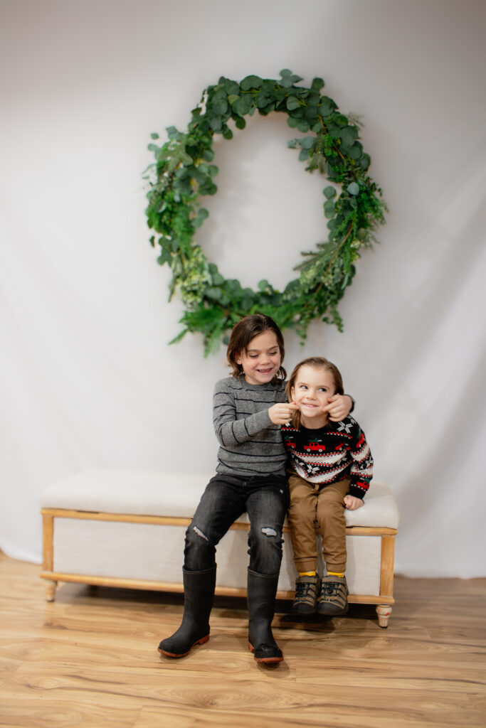 Playful sons pose for christmas mini session in Roseburg Oregon by McKenzie Strong Photography.