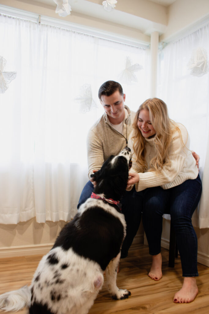 Roseburg Oregon couple pet dog during Christmas mini session taken indoors by McKenzie Strong Photography.