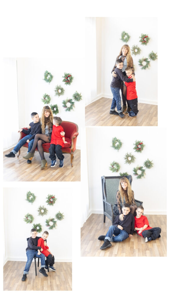 Mother photographed with her two sons during a Roseburg Oregon Christmas mini session, posing together in a bright studio with holiday wreaths